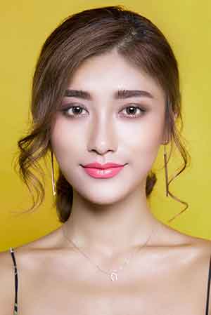 Woman with styled hair and a yellow background